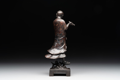 A fine Chinese bronze Luohan holding a sutra, Ming