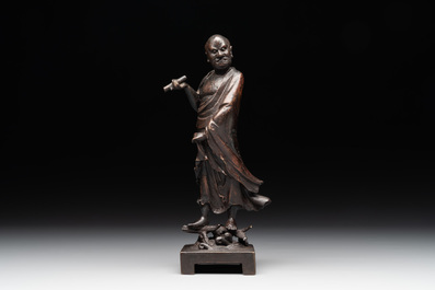 A fine Chinese bronze Luohan holding a sutra, Ming