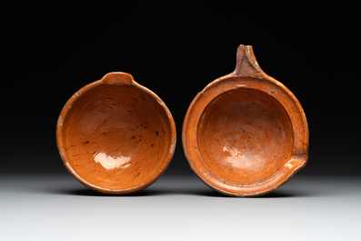 Five pieces of glazed earthenware cooking utensils and a fire bell, probably The Netherlands, 17th C.