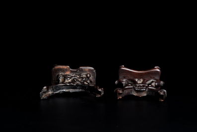 A Chinese russet jade 'bi' disc and a spinach-green flower-shaped pendant on wooden stands, Ming and Qing