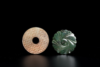 A Chinese russet jade 'bi' disc and a spinach-green flower-shaped pendant on wooden stands, Ming and Qing