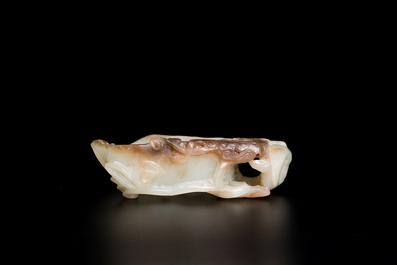 A Chinese white and russet jade lotus-form brush washer and two covered vases, Qing