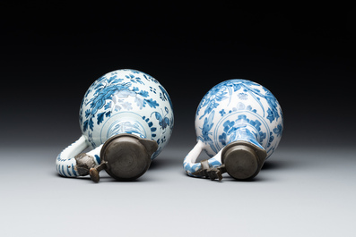 Two Dutch Delft blue and white jugs with pewter lids, 17/18th C.