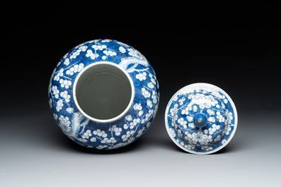 Two Chinese blue and white 'prunus on cracked ice' vases and covers, Kangxi mark, 19th C.