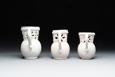Three French white-glazed and two polychrome puzzle jugs, Nevers, 18th C.