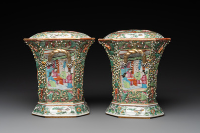 A pair of Chinese Canton famille rose flower holders and covers with figural design, 19th C.