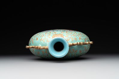 A Chinese gilt-decorated famille rose turquoise 'monkeys' and 'dogs' moon flask, Qianlong mark, 20th C.