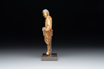 A Chinese gilt and polychromed stucco figure of a monk, Ming