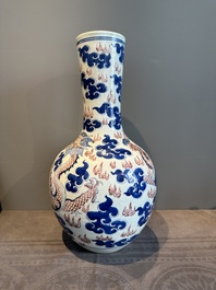 A Chinese blue, white and copper-red 'dragon and phoenix' vase, 19th C.