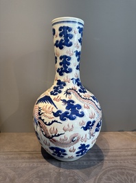 A Chinese blue, white and copper-red 'dragon and phoenix' vase, 19th C.