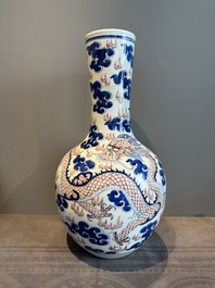 A Chinese blue, white and copper-red 'dragon and phoenix' vase, 19th C.