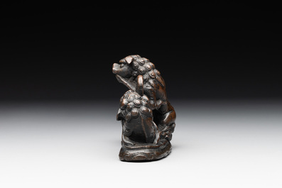 A rare Chinese bronze 'three dancing lions' paperweight or brush rest, Ming