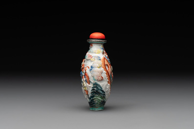 A Chinese famille rose relief-molded snuff bottle with narrative design, Xianfeng mark and of the period