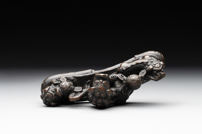 A rare Chinese bronze 'three dancing lions' paperweight or brush rest, Ming