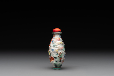 A Chinese famille rose relief-molded snuff bottle with narrative design, Xianfeng mark and of the period