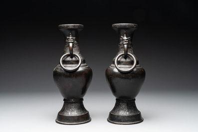 A pair of Chinese bronze vases with 'dragon' handles, Yuan/Ming