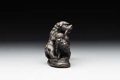 A rare Chinese bronze 'three dancing lions' paperweight or brush rest, Ming