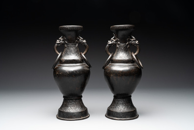 A pair of Chinese bronze vases with 'dragon' handles, Yuan/Ming