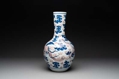 A Chinese blue, white and copper-red 'dragon and phoenix' vase, 19th C.