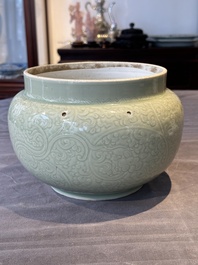 A Chinese incised celadon-glazed bowl with chilong and floral design, Kangxi