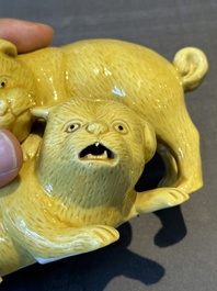 A Japanese monochrome yellow-glazed 'two playing dogs' group, 19th C.
