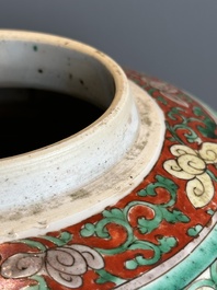 A Chinese famille verte jar with floral design and a wooden cover, Kangxi