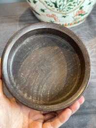 A Chinese famille verte jar with floral design and a wooden cover, Kangxi