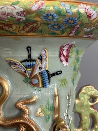 A pair of Chinese Canton famille rose celadon-ground 'court scene' vases, 19th C.