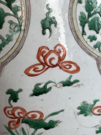 A Chinese famille verte jar with floral design and a wooden cover, Kangxi