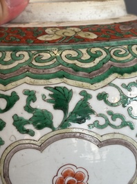 A Chinese famille verte jar with floral design and a wooden cover, Kangxi