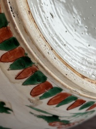 A Chinese famille verte jar with floral design and a wooden cover, Kangxi