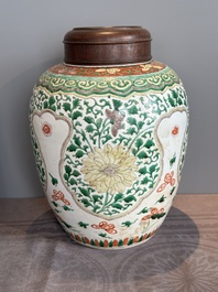 A Chinese famille verte jar with floral design and a wooden cover, Kangxi