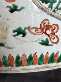 A Chinese famille verte jar with floral design and a wooden cover, Kangxi