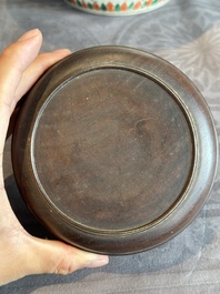 A Chinese famille verte jar with floral design and a wooden cover, Kangxi