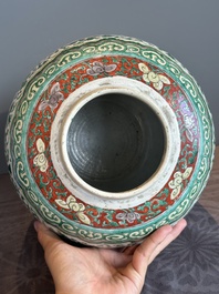 A Chinese famille verte jar with floral design and a wooden cover, Kangxi