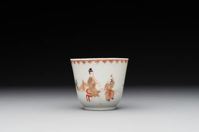 A Chinese famille rose cup and saucer with a lady playing flute, a boy and a phoenix, Qianlong