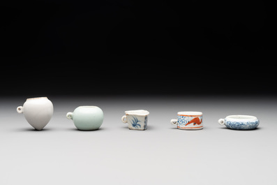A collection of nine Chinese blue and white, monochrome and famille rose bird feeders, 19th C.