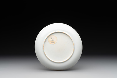 A Chinese famille rose cup and saucer with a lady playing flute, a boy and a phoenix, Qianlong