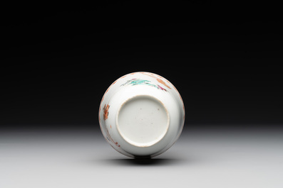 A Chinese famille rose cup and saucer with a lady playing flute, a boy and a phoenix, Qianlong