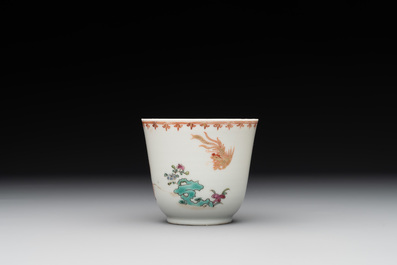 A Chinese famille rose cup and saucer with a lady playing flute, a boy and a phoenix, Qianlong