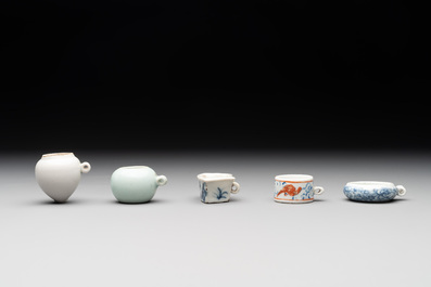 A collection of nine Chinese blue and white, monochrome and famille rose bird feeders, 19th C.
