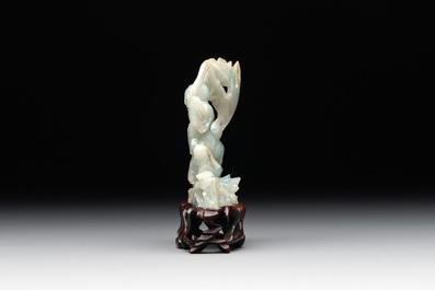 A Chinese jade 'He He Er Xian' group on wooden stand, 19th C.