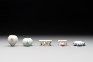 A collection of nine Chinese blue and white, monochrome and famille rose bird feeders, 19th C.