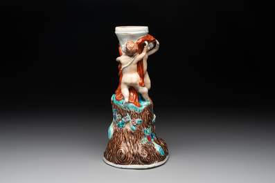 A Chinese export faux-bois stand with two putti and two famille rose boys, Qianlong/Jiaqing