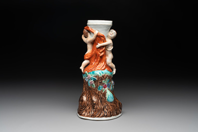 A Chinese export faux-bois stand with two putti and two famille rose boys, Qianlong/Jiaqing