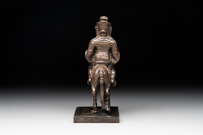 A rare Chinese bronze Vaishravana on horseback with wooden stand, Yuan