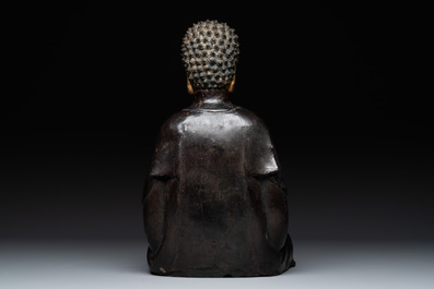 A large Chinese lacquered and gilt bronze Buddha, 17th C.