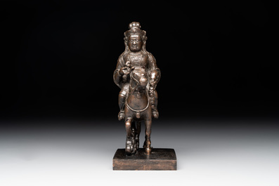 A rare Chinese bronze Vaishravana on horseback with wooden stand, Yuan