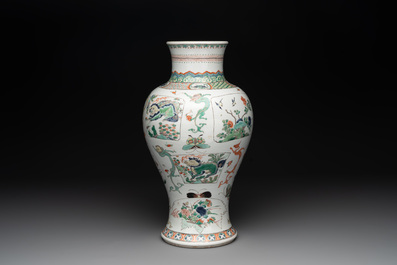 A fine Chinese famille verte 'mythical creatures' vase on a reticulated wooden stand, Kangxi