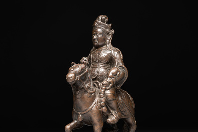 A rare Chinese bronze Vaishravana on horseback with wooden stand, Yuan